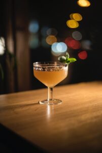 clear cocktail glass on brown wooden table