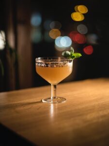 clear cocktail glass on brown wooden table