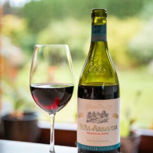 a bottle of wine and a glass of wine on a table